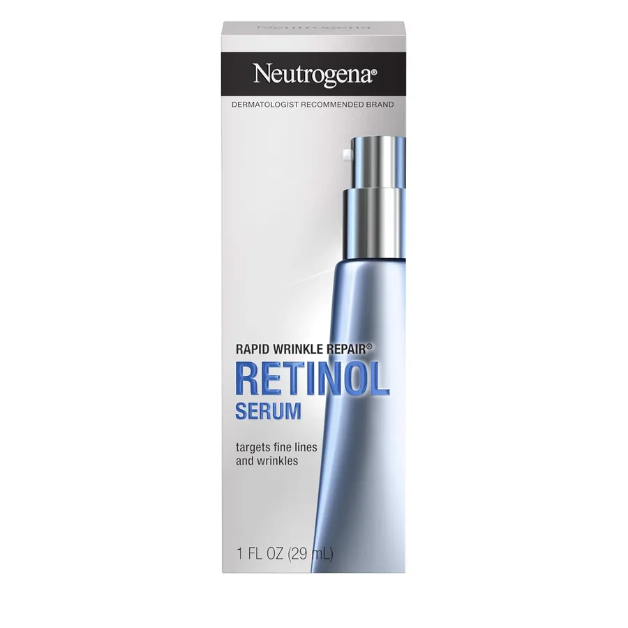 Hand holding the Neutrogena Rapid Wrinkle Repair Retinol Serum pump bottle over an open palm, bathroom vanity in background